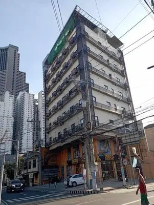 a tall building on a city street with cars at St. Marvin Studio Makati M307 in Manila