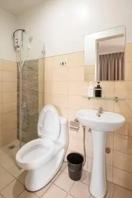 a bathroom with a toilet and a sink at St. Marvin Studio Makati M306 in Manila