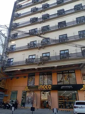 a large building with a store on the side of it at St. Marvin Studio Makati M302 in Manila