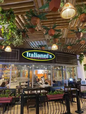 a restaurant with people sitting at tables in a restaurant at Elegant 2BR, 2 BA Suite Beside Eastwood Mall in Manila