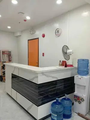a kitchen with a counter with blue water bottles at St. Marvin Studio Makati M204 in Manila