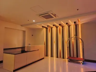 a kitchen with a island in a room with windows at Palmtree Two Villas Across Terminal 3 or Manila Airport in Manila