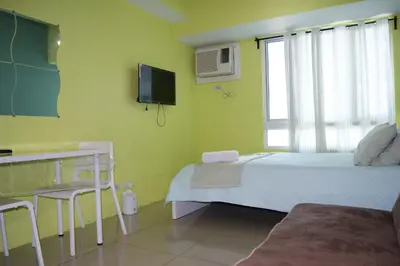 a hospital room with a bed and a tv at The Beacon Makati by mvmtransient in Manila