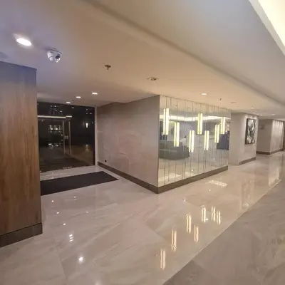 a lobby with a chandelier in a building at Homely Green 2 Residences T2 in Dasmariñas