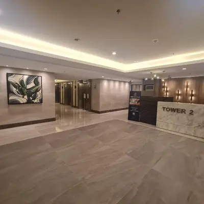 a lobby of a hotel with a sign that reads tower at Homely Green 2 Residences T2 in Dasmariñas