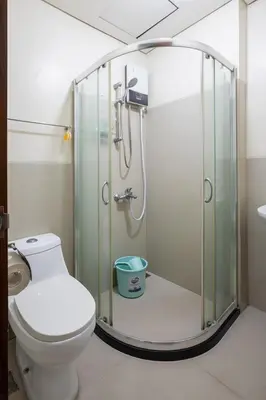 a bathroom with a shower and a toilet at The Beacon Makati by mvmtransient in Manila