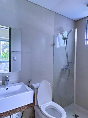 a bathroom with a toilet and a sink and a shower at 1BR at TWO PALMTREE VILLAS Across Manila airport terminal 3 in Manila