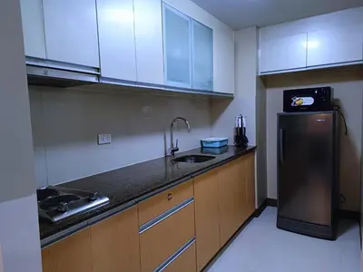 a kitchen with a sink and a refrigerator at 1BR at TWO PALMTREE VILLAS Across Manila airport terminal 3 in Manila
