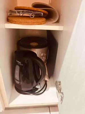 a cupboard with a coffee maker and a tea pot at Relaxing 1-Bedroom Unit in Azure Urban Resort and Residences by One Guest Place in Manila