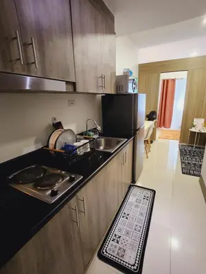 a kitchen with a sink and a counter top at Fame Residences Staycation in Manila