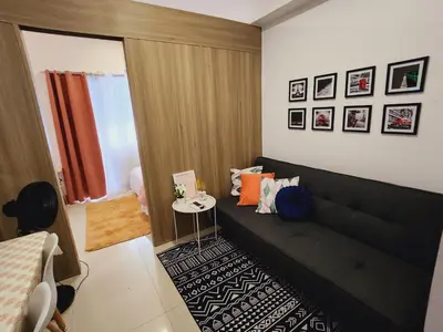 a living room with a couch and a table at Fame Residences Staycation in Manila