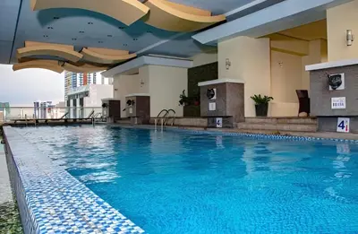 a large swimming pool on the roof of a building at Birch Tower in Manila