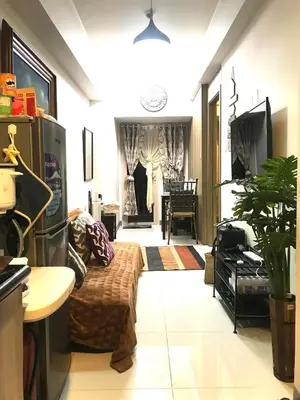 a living room with a couch and a table at LJ'S Escape 1BR Coast Residences in Manila