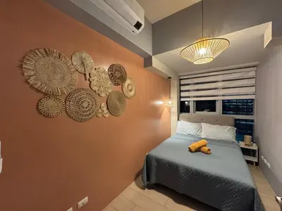 a bedroom with a bed with a teddy bear on it at Glamorous 3BR Suite in Uptown BGC w/Bathtub in Manila