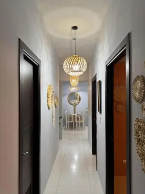 a hallway with a chandelier and a hallway with a dining room at Glamorous 3BR Suite in Uptown BGC w/Bathtub in Manila