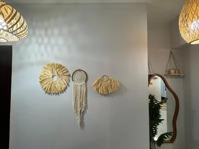 a wall with two dried feathers and a mirror at Glamorous 3BR Suite in Uptown BGC w/Bathtub in Manila