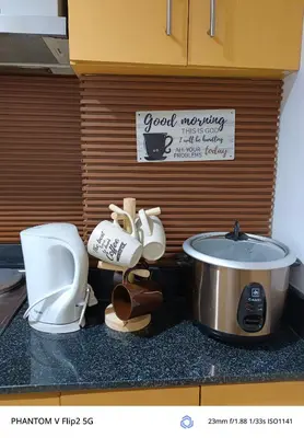 a kitchen counter with a toilet and a sink at Sea Residence Finest in Manila