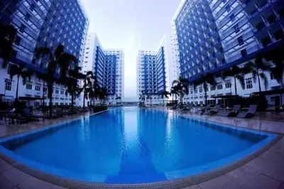 a large swimming pool in a city with tall buildings at Sea Residence Finest in Manila
