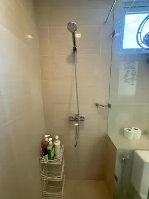 a shower in a bathroom with a glass door at The Verdin at Maple Grove in Cavite