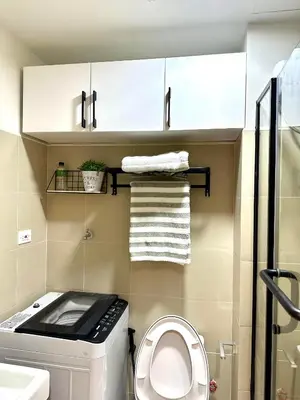 a small bathroom with a washer and dryer at SMDC Shore 3 Residences - One Bedroom Unit in Manila