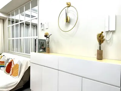 a kitchen with white cabinets and a mirror at SMDC Shore 3 Residences - One Bedroom Unit in Manila