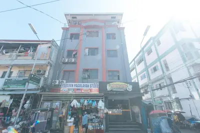 a building with a store on a city street at MCP Transient near NAIA in Manila