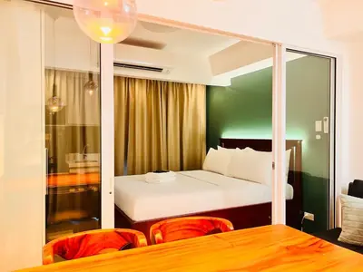 a bedroom with a bed and a table and chairs at Manila Philippines, Azure Urban Resort Staycation by Leroche near Ninoy Aquino International Airport in Manila