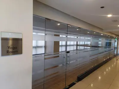 a row of glass doors in a building at -CONDO- Petite Residential Stay in Manila