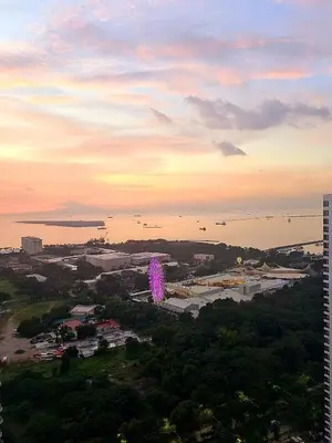 a view of a city with a purple object in the sky at Cozy Penthouse 2BR Suite w Balcony - Amazing Manila Bay View and City Skyline near MOA in Manila