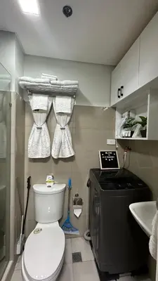 a small bathroom with a toilet and a sink at Cozy Condo near Mall of Asia in Manila
