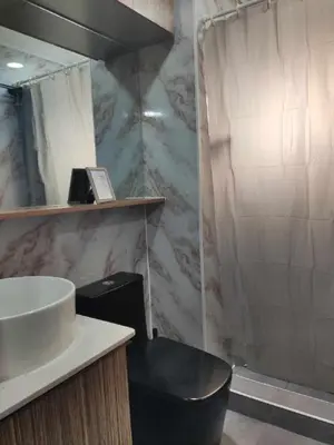 a bathroom with a sink and a shower at Cozy Studio Unit near Manila Airport With Swimming Pool, Full Kitchen 7A in Manila