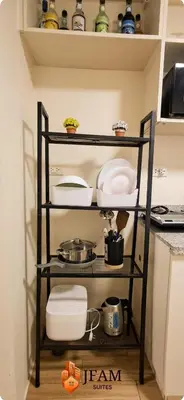 a shelf in a kitchen with dishes on it at JFam Suites, C3-3N Studio, Up To 4 Pax in Biñan