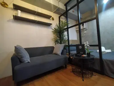 a living room with a couch and a table at Brand New Studio in Pasig with Free Pool Access in Manila