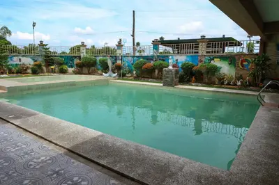 a swimming pool in front of a building at Villa Elsie Resort and Hotel in General Trias