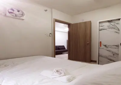 a bedroom with a white bed and a mirror at S Residences1 bedroom with balcony near MOA in Manila