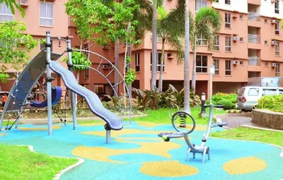 a playground in a park with a slide at Near Manila Airport, MAILZ HOMEZ COZY 1 Bedroom Condo, Full Kitchen, Swimming Pool, WIFI, 10L in Manila