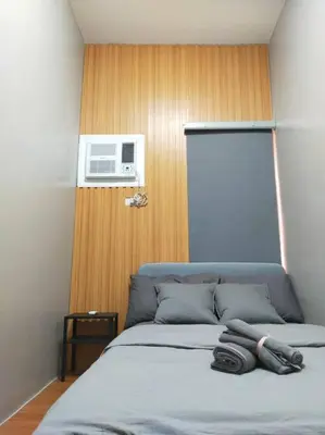 a bedroom with a bed with a air conditioner at Stylish 2BR w/ Free Pool Access and Parking LG03 in Manila