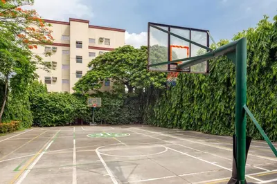 a basketball hoop on a court in front of a building at Cozy 2BR w/ Free Pool Access and Free Parking N224 in Manila