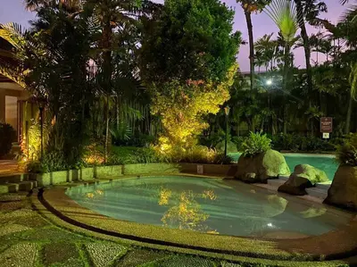 a small swimming pool in a yard with trees at Cozy 2BR w/ Free Pool Access and Free Parking N224 in Manila