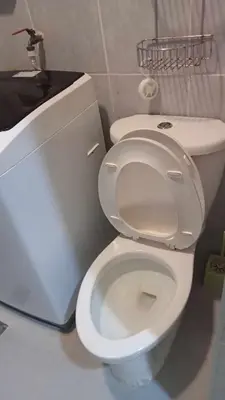 a bathroom with a white toilet in a room at MOA Staycation - Ashti in Manila