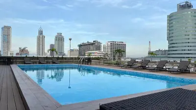 a large swimming pool on the roof of a building at Pearl Manila Hotel in Manila