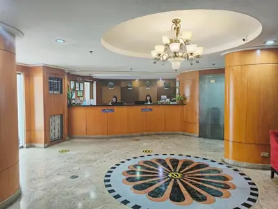 a large lobby with a large rug on the floor at Pearl Manila Hotel in Manila