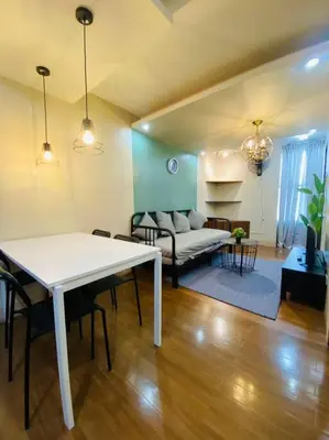a living room with a white table and a couch at Spacious 2BR w/ Free Pool Access and Parking (709) in Manila