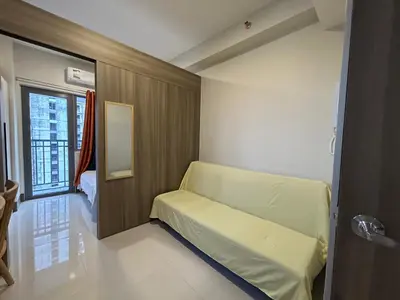 a small room with a bed and a window at Cairong Inn Condominium TV with Netflix FAME RESIDENCES in Manila