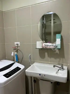 a bathroom with a sink and a mirror at Cairong Inn Condominium TV with Netflix FAME RESIDENCES in Manila