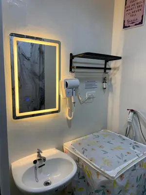 a hospital room with a sink and a bed at PARANAQUE STAYCATION at SPRING RESIDENCES T3 U1231 in Manila