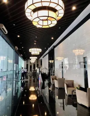 a lobby with chairs and chandeliers in a building at UNIT 4765 AIR in Manila