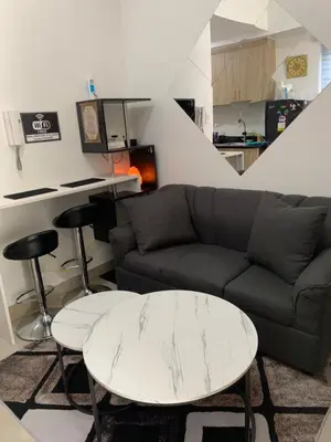 a living room with a couch and a table at SHORE 2 MOA Staycation T2 U1712 in Manila