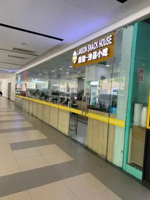 an empty shopping mall with a large glass window at SHORE 2 MOA Staycation T2 U1712 in Manila