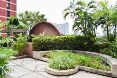 a garden with plants and trees in a building at Sunette Tower Suites Makati City Center in Manila